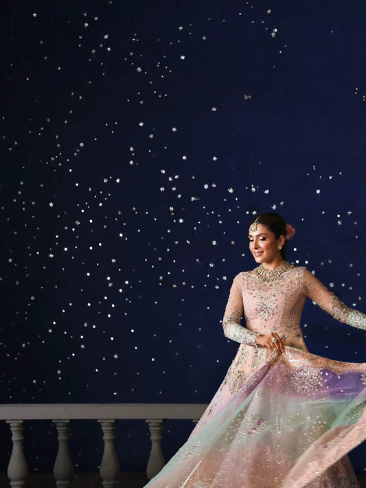 Woman in a sparkling dress against a starry night sky