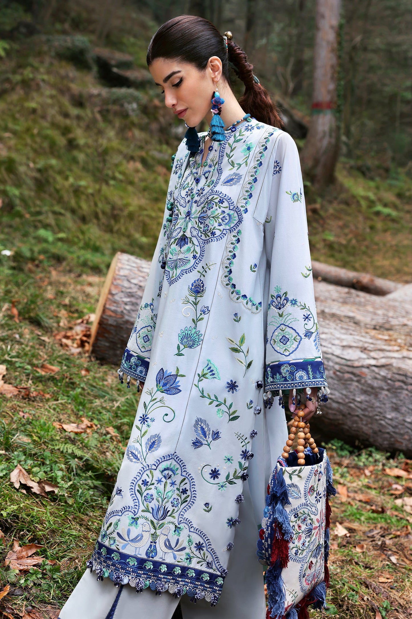 Zaha Summer 2025 unstitched embroidered lawn suit with satin borders, voile dupatta, and cambric trousers—ideal for festive wear.