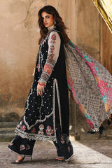 Woman in traditional black and white outfit with floral patterns walking outdoors.