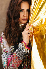 Woman holding a gold fabric with intricate patterns