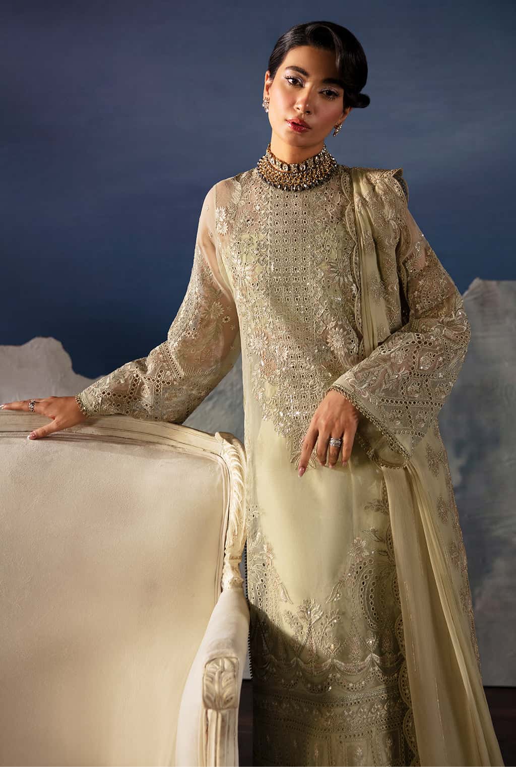 Woman in a traditional embroidered outfit with a scenic background