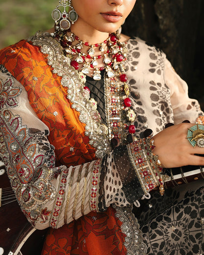 Person wearing traditional jewelry and attire with intricate designs.