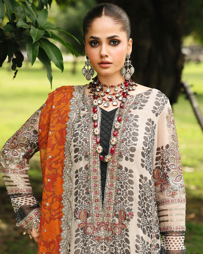 Woman wearing a traditional outfit with intricate patterns in an outdoor setting