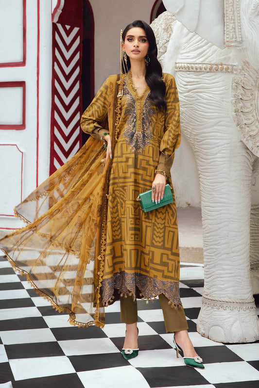 Woman in a mustard yellow traditional outfit standing in a decorative interior setting.