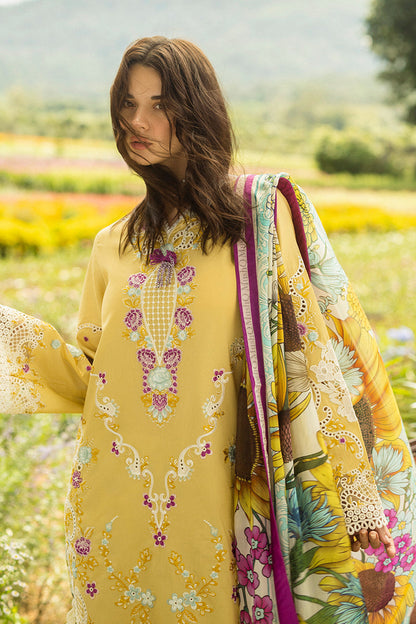Woman in a yellow embroidered dress with a floral pattern in a field