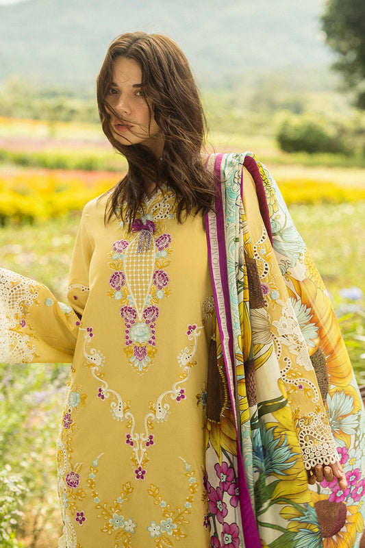 Woman in a yellow embroidered dress with a floral pattern in a field