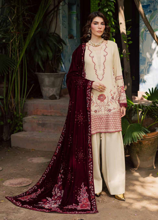 Woman wearing a traditional outfit with a maroon dupatta and white pants in an outdoor setting.