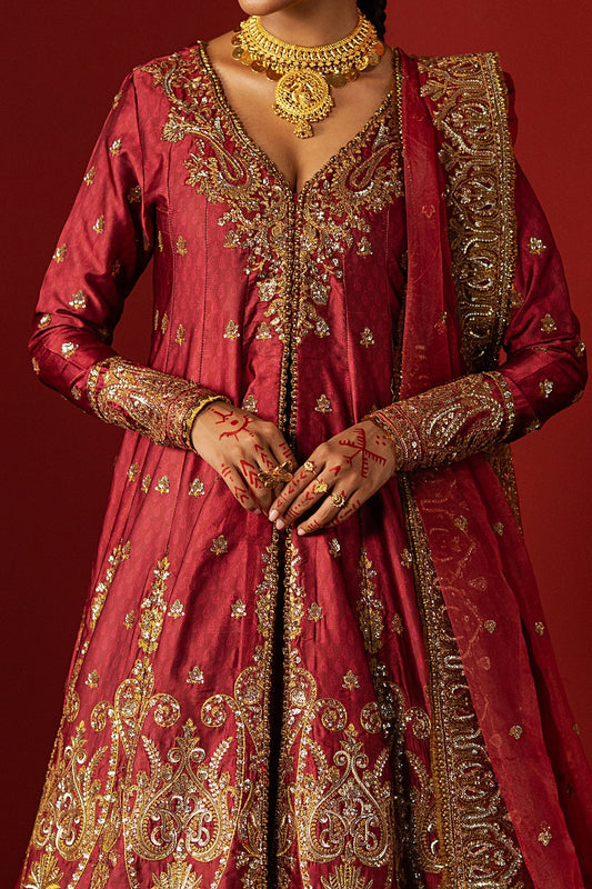 Red embroidered traditional outfit with gold detailing on a red background